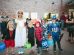 children standing while holding Jack 'o lantern and wearing costume