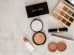 photo of assorted makeup products on gray surface