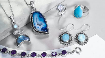 a collection of jewelry on a white surface