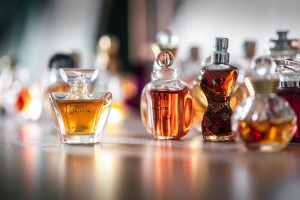 selective focus photography of clear glass perfume bottle