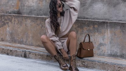 woman sitting on pathway during daytime