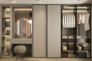 a walk in closet with a mirror and a stool