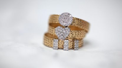 three gold-colored studded rings